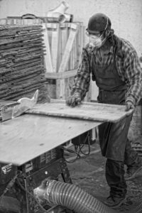 Photo of a man making Bark House birch products - innovative and sustainable wood products on elemental green