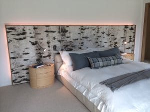 Photo of a headboard made from Bark House birch bark material - innovative and sustainable wood products on elemental green
