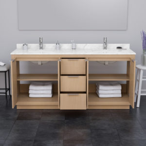 Wyndham vanity in light color with three drawers and two open cabinet doors showing white towels stacked; vanity had dual sinks with silvery fittings