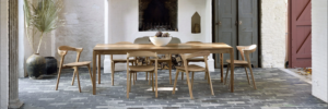 Viesso Ethnicraft Bok Oak Extendable Dining Table in courtyars dining space; fireplace and firewood on beick pavers - photo