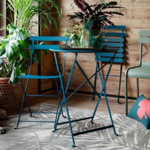 Viesso Fermob Bistro Metal Chair and table in interior setting with abundant plants - photo