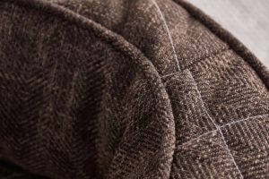 Closeup of Brentwood Home pet cover featuring quilted sticking on warm brown fabric - photo