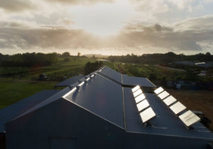 home with source water filtration hydropanels at dusk, renewable energy