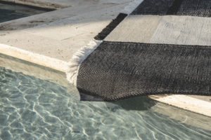 outdoor rug laying by a pool