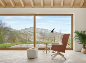 lounge chair and ottoman in front of large window