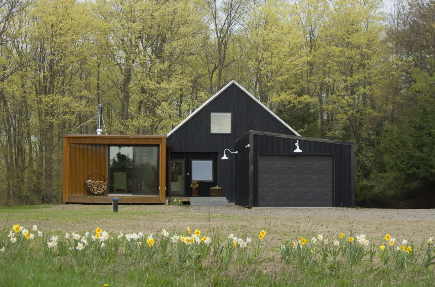 Exterior of a prefab house with a black and brown finish, WeeBarnHouse by Alchemy prefab house