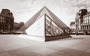 Black and white photo of the Pyramid sculpture at the Louvre Museum in Paris designed by I.M. Pei
