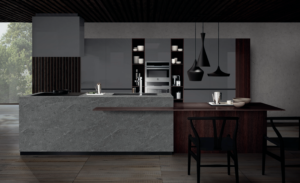 Gray kitchen cabinets with dark wood island and black pendants