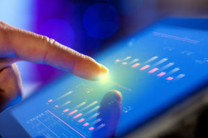 Closeup of finger touching tablet screen, monitoring solar production and storage