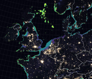 ap shows dark outlines of land masses that include the UK, Ireland, France, Belgium, Netherlands, Germany, and Denmark. Bright bursts of light are especially clear where Paris and London exist on the map. The North Sea is largely dark, contrasting the light pollution emitted from cities on land.