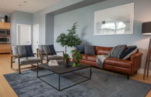 Beautiful brown leather sofa in livingroom deorated in shades of gray