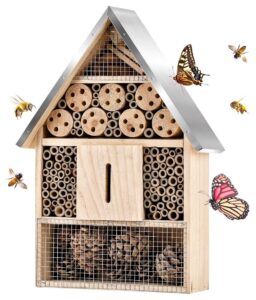Wood insect "home" in the shape of a bird house on white background, surrounded by butterflies, bees, and other flying insects - photo