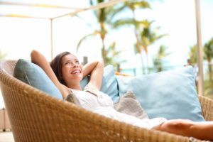 Sofa with Woman relaxing enjoying luxury lifestyle outdoor day dreaming and thinking looking happy up smiling cheerful. Beautiful young multicultural Asian Caucasian female model in her 20s.