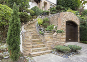 Stone Veneer Siding on Home Exterior with Stone Stair Manicured Front Entrance Yard Landscape