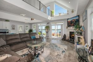 Custom modular home with beautiful interior design, high ceilings, fireplace, expansive view of waterway