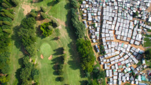 aerial photo of verdant golf course in Durban South Africa that abuts a slum with little trees or plantings