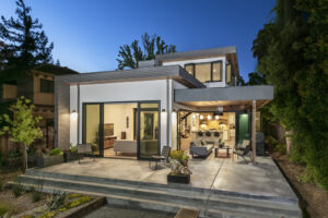 Modern looking house at dusk featuring indoor-outdoor living space - photo