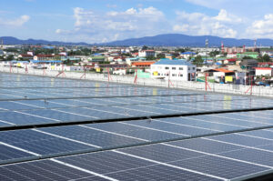 Solar PV System on Industry Roof with City Background - photo