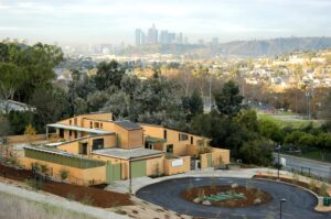 hilltop view of Audubon Center in Los Angeles; greywater system shows at center; park, buildings, and skyline in background - photo