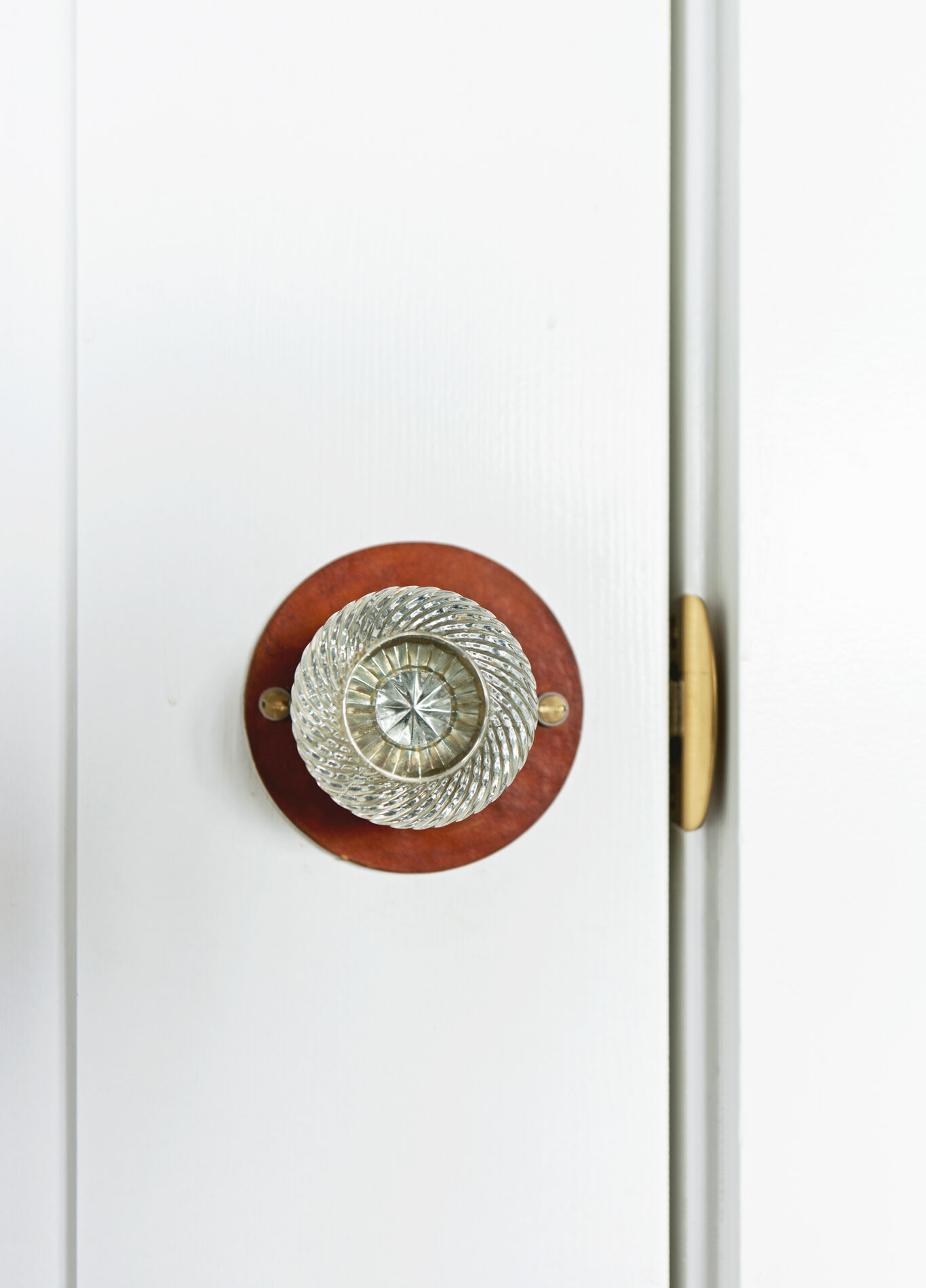 Closeup of decorative glass doorknob (salvaged) with leather rosette - photo