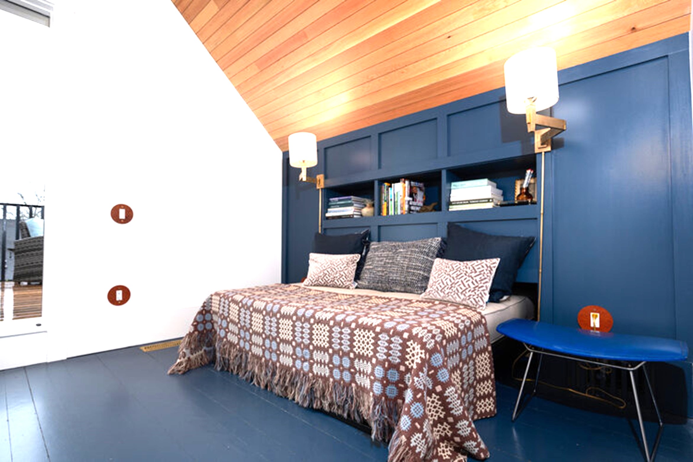 Hemp covered, buttoned daybed in room with blue floor and dormered ceiling - photo