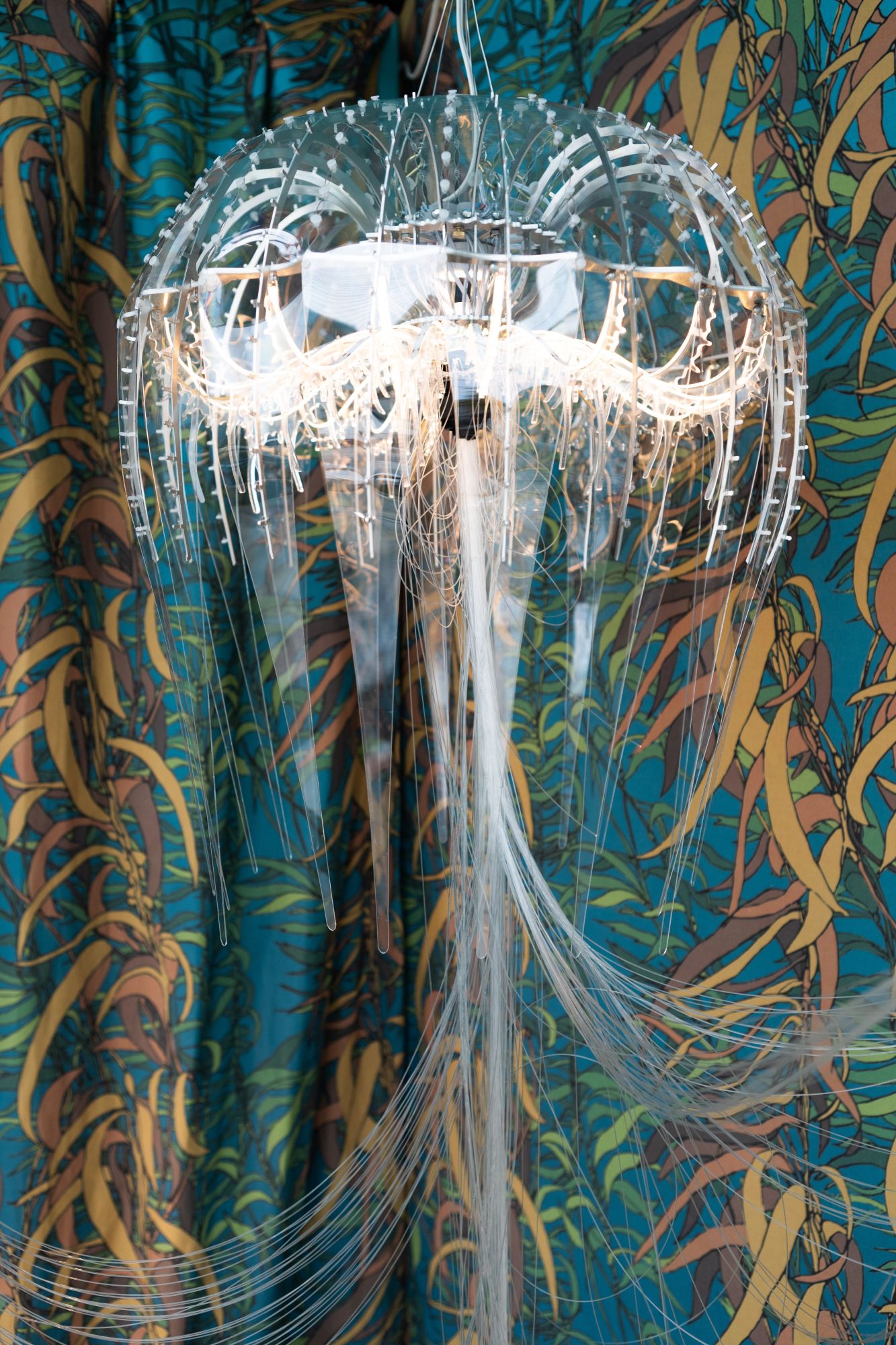 Glowing jellyfish chandelier on colorful background - photo