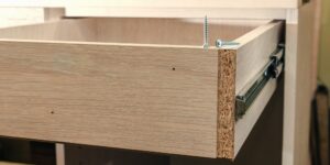 Closeup of drawer assembly showing funner and extra screws - photo