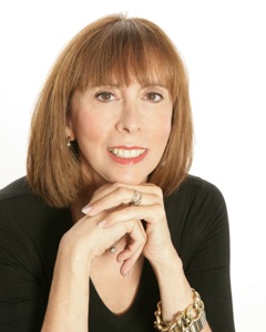 headshot of author Sheri Koones - smiling woman with folded hands - photo